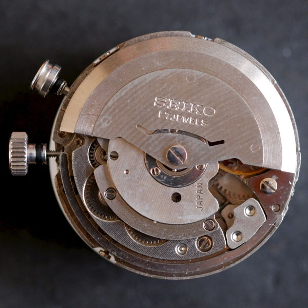 Thumbnail image of Seiko movement 4406A. You can see the curved sounding spring around the lower edge of the case, which is repeatedly hit to create the alarm sound.